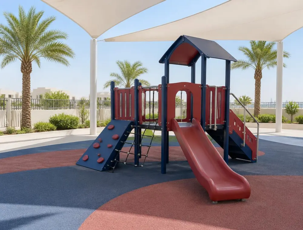 Outdoor playground with a climbing frame and slide under shade sails