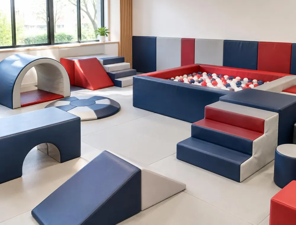 Indoor soft play room with foam blocks, ramps and a ball pit